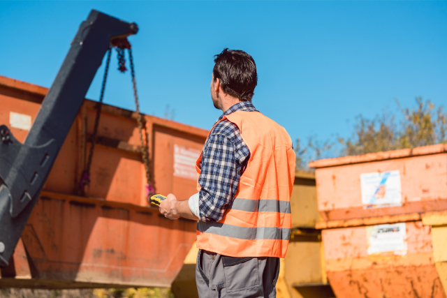 Concrete Crushing and Recycling bins with worker operating a machine