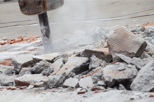 Demolishing Concrete with a strong jackhammer power tool